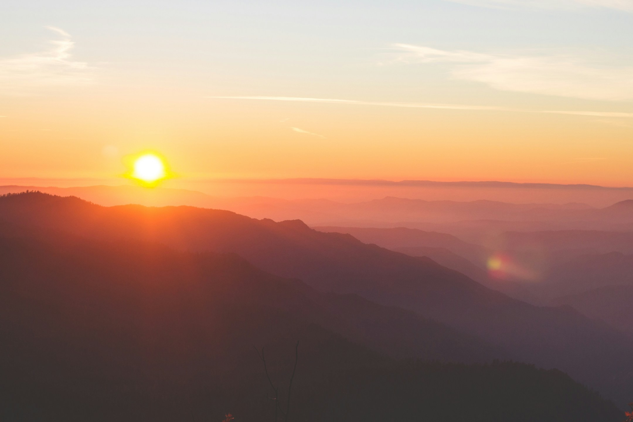 A blurry photo of a sunrise taken by a hiker using a phone camera