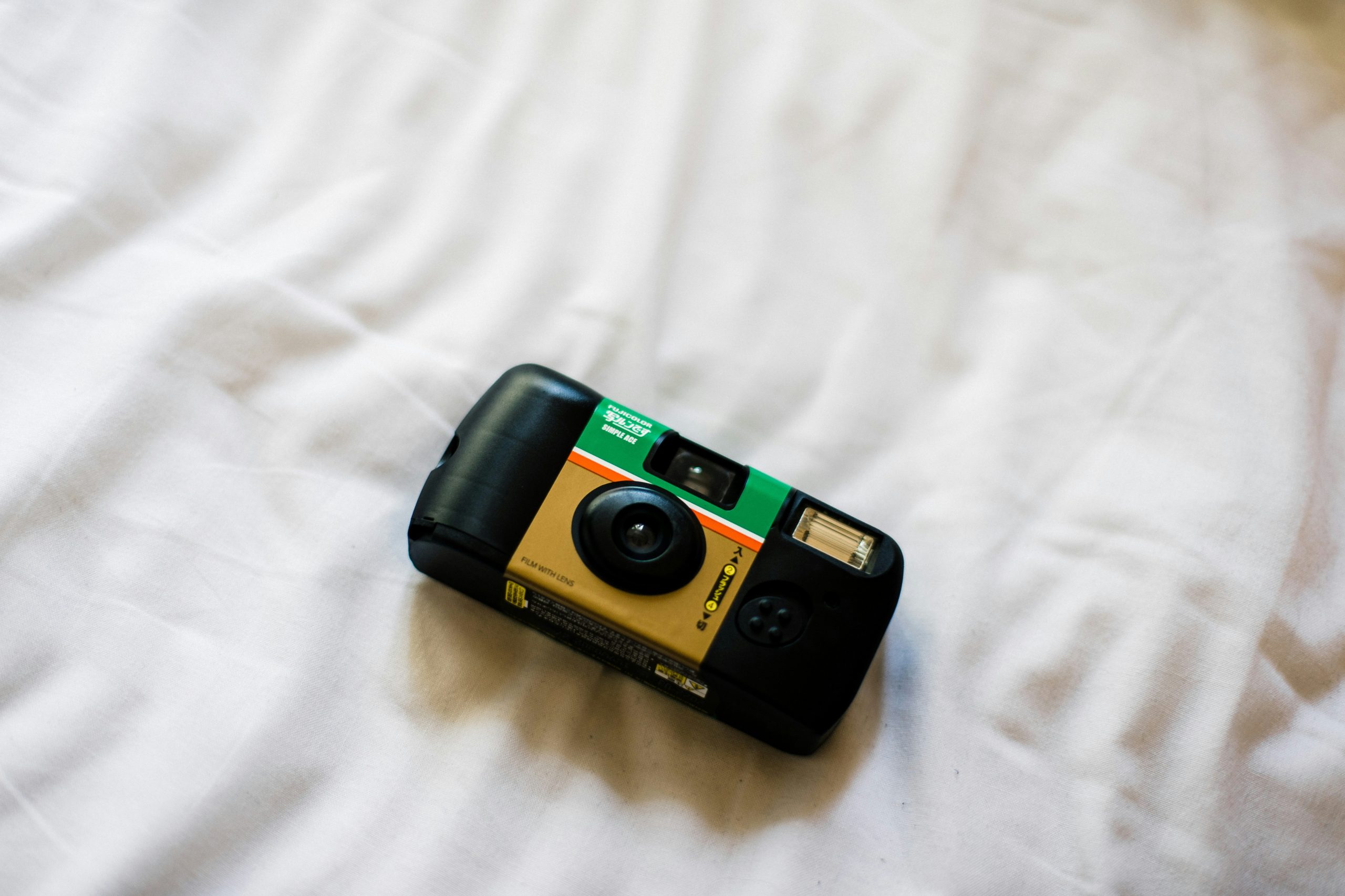 A dusty trail camera with smudges on the lens
