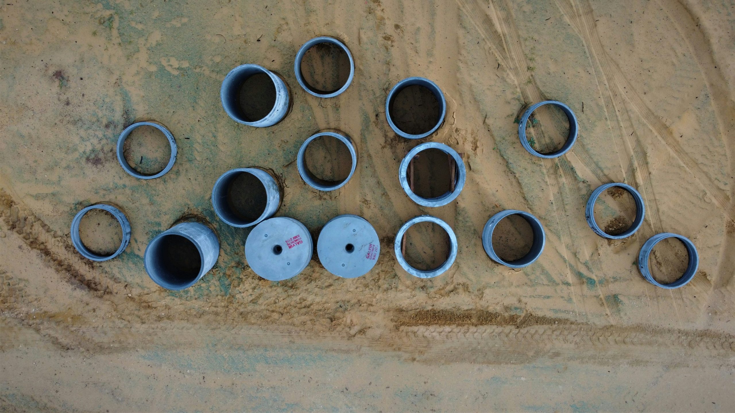 An organized setup of various hiking camera gears including lenses, tripod, and protective cases.