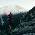hiker with camera on mountain trail