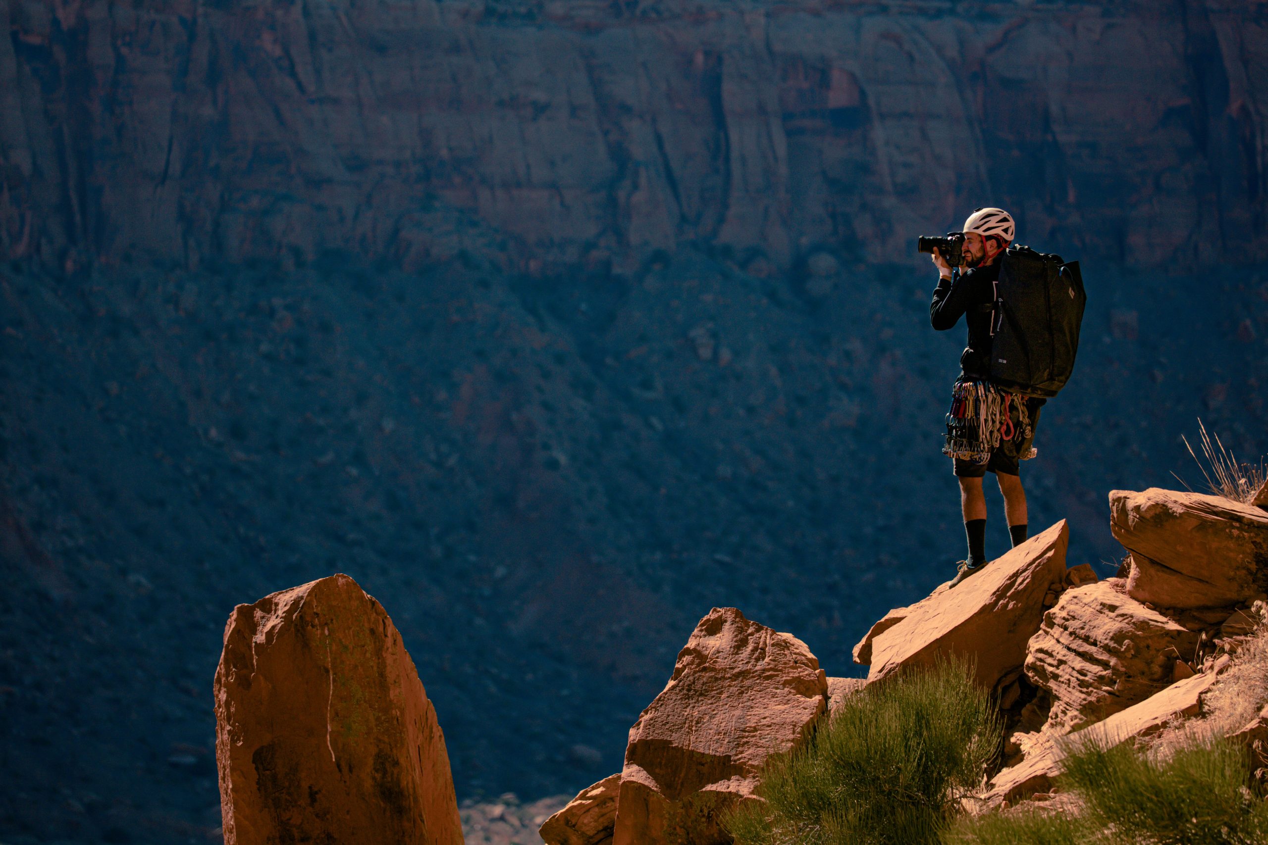 Man adjusting position of a trail camera while hiking outdoors